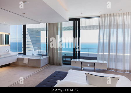 Modern bedroom overlooking ocean Stock Photo