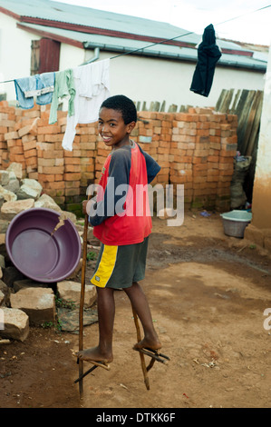 Madagascar, Antsirabe, boy walking on wooden stilts Stock Photo