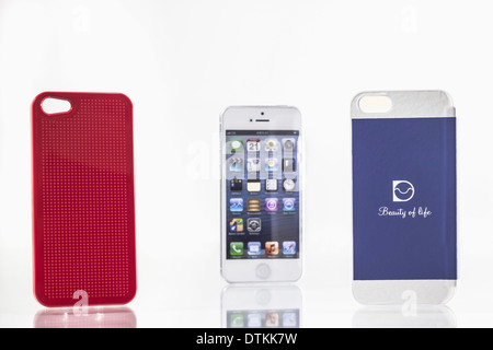 stylish mobile phone and its bright blue and red covers Stock Photo