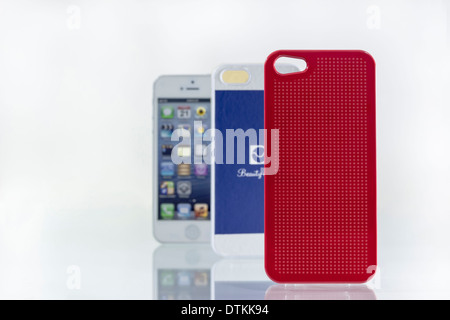 stylish mobile phone and its bright blue and red covers Stock Photo