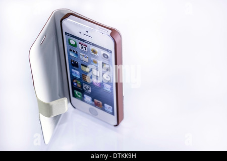 cell phone and their stylish brown cover Stock Photo