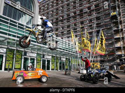 Hamburg, Germany. 20th Feb, 2014. Portugese stuntman Ricardo Domingos jumps over a four wheeler and mini-hotrod outside of the entrance to the expo center in Hamburg, Germany, 20 February 2014. The Hamburg Motorcycle Days will take place from 21 until 23 February at the Hamburg Convention Center. Photo: AXEL HEIMKEN/dpa/Alamy Live News Stock Photo