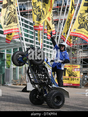 Hamburg, Germany. 20th Feb, 2014. Portugese stuntman Ricardo Domingos poses on his motocycle outside of the entrance to the expo center in Hamburg, Germany, 20 February 2014. The Hamburg Motorcycle Days will take place from 21 until 23 February at the Hamburg Convention Center. Photo: AXEL HEIMKEN/dpa/Alamy Live News Stock Photo