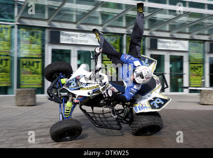 Hamburg, Germany. 20th Feb, 2014. Portugese stuntman Ricardo Domingos performs a stunt on a four-wheeler outside of the entrance to the expo center in Hamburg, Germany, 20 February 2014. The Hamburg Motorcycle Days will take place from 21 until 23 February at the Hamburg Convention Center. Photo: AXEL HEIMKEN/dpa/Alamy Live News Stock Photo