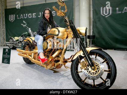 Hamburg, Germany. 20th Feb, 2014. Model Ramona poses on the 650,000 euro most expensive motorcycle in the world from Danish motorcycle manufacturer Lauge Jensen, a modified Harley Davidson, at the expo center in Hamburg, Germany, 20 February 2014. The Hamburg Motorcycle Days will take place from 21 until 23 February at the Hamburg Convention Center. Photo: AXEL HEIMKEN/dpa/Alamy Live News Stock Photo