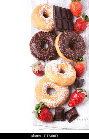 Top view on sugar and chocolate donuts, fresh strawberries and dark chocolate over white Stock Photo