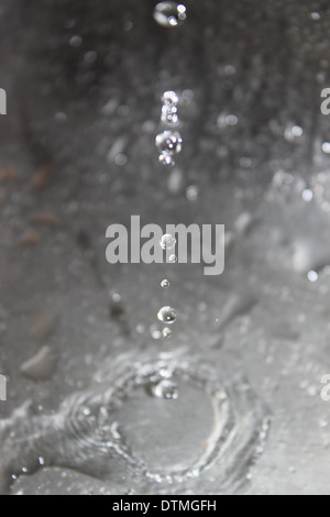 Drops of water fall and are frozen in photo Stock Photo