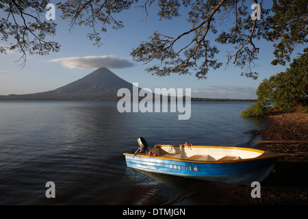 Ometepe Island, a small boat on the shore of  Lake Nicaragua with Concepcion Volcano in the background Stock Photo