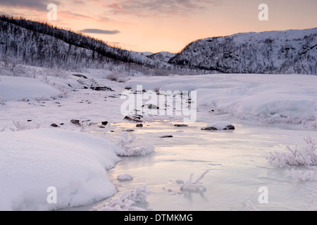 A snow covered frozen river in the mountains near Tromso, Norway Stock Photo