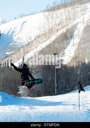 A snowboarder jumping hi in the air. Stock Photo
