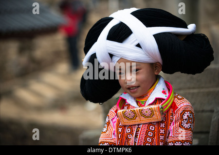 A Long Horn Miao little girl in traditional costumes dancing to celebrate the Tiao Hua festival / spring festival in Guizhou. Stock Photo