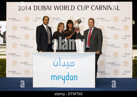 Meydan Racecourse, Dubai, UAE. 20th Feb 2014. The winners receive their trophy after winning Race 3 during the 7th meeting of the Dubai World Cup Carnival At Meydan Racecourse Credit:  Tom Morgan/Alamy Live News Stock Photo