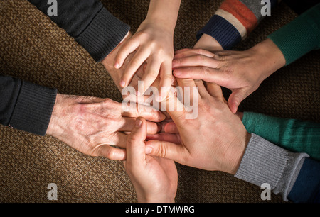 Many hands together. Interior shot Stock Photo