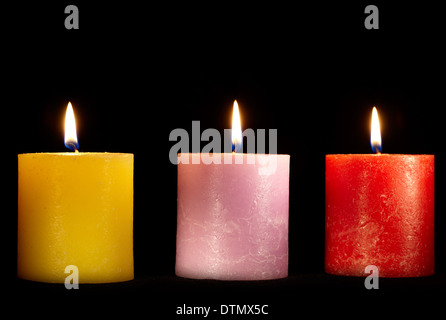 Three candles on black. Stock Photo