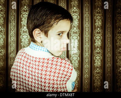 Frowning child vintage clothes. Close up shot Stock Photo