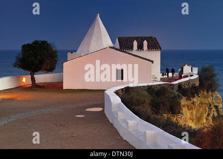 Portugal, Algarve, Armacao de Pera, Porches, Nossa Senhora da Rocha, chapel, rock, sea, ocean, small sanctuary, fishermen, chapel on a rock, sea view, night, evening, illumination, travel, tourism, sightseeing, highlights of the Algarve, nature, erosion, r Stock Photo