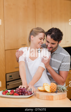 Portrait of a lovely couple eating fruits Stock Photo