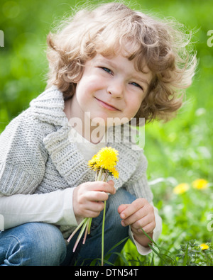 Child with bunch of dandelion Stock Photo