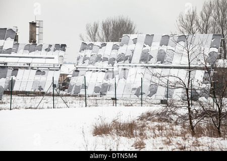 Photovoltaic solar panels covered by snow in winter. Stock Photo