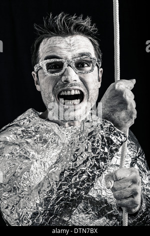 Crazy spaceman holding rope. Stock Photo