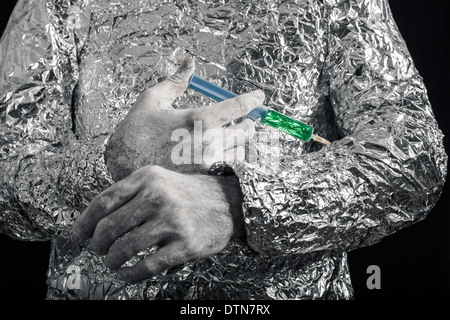 Closeup of cyborg hand applying syringe. Stock Photo