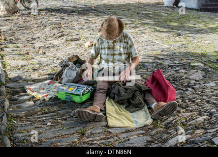 An artist painter at work in the seaside town of Cadaques, Cap de Creus peninsula, Costa Brava, Catalonia, Spain Stock Photo