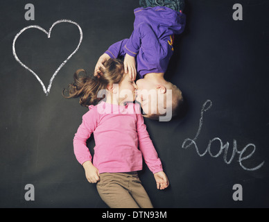 Smiling children on a blackboard background Stock Photo