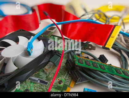 A pile of old computer parts including ram, fan, graphics card, wires, ribbon etc Stock Photo