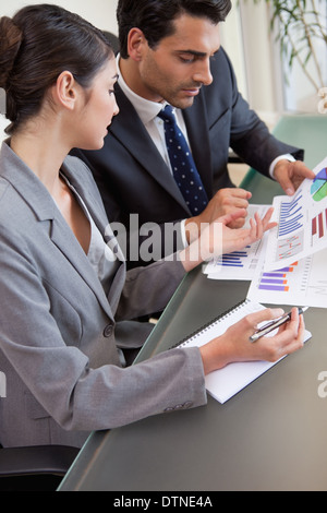 Portrait of sales persons studying graphs Stock Photo