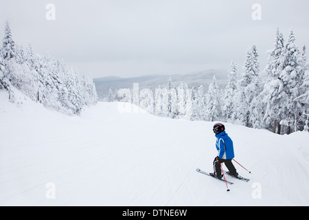 Mont-Tremblant, Canada - February 9, 2014: A boy is skiing down an easy slope at Mont-Tremblant. Stock Photo