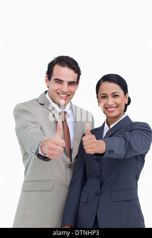 Smiling young salesteam giving thumbs up Stock Photo