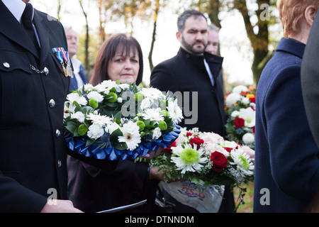 Guests with flowers wait to pay tribute at the grave of PC James Gordon, who was murdered on duty in 1893. Stock Photo