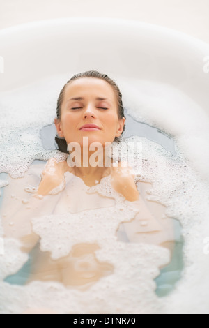 Young woman laying in bathtub Stock Photo