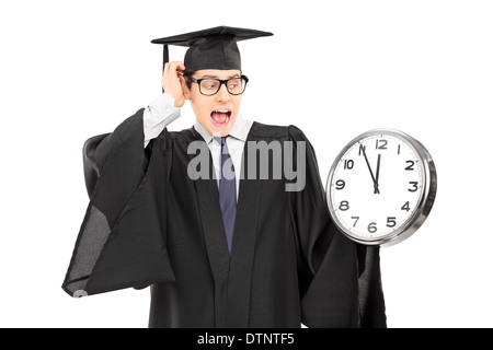 Surprised man looking at a big wall clock Stock Photo