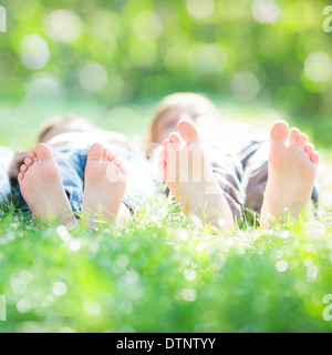 Family lying on grass Stock Photo
