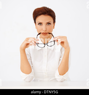 Beautiful businesswoman holding spectacles Stock Photo