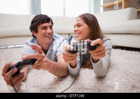 Happy couple playing video games together Stock Photo