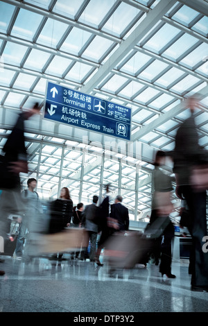 people moving blur in modern airport hall Stock Photo