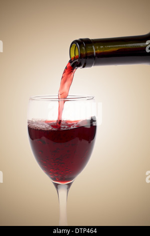 red wine pouring with glass and bottle Stock Photo