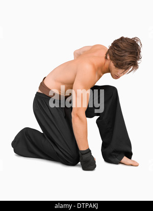 Kneeling martial arts fighter Stock Photo