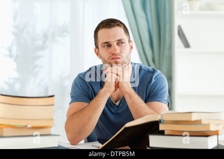 Student sitting at his desk in thoughts Stock Photo