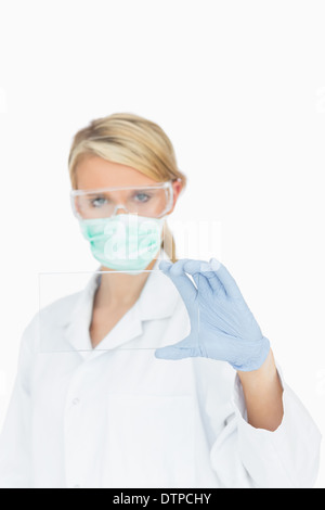Surgeon looking through clear pane Stock Photo