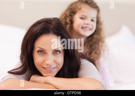 Mother and daughter relaxing on the bed Stock Photo