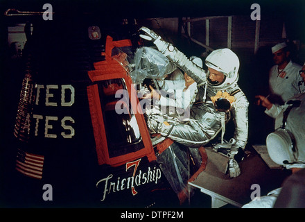 US astronaut John Glenn Jr., pilot of the Mercury Atlas 6, climbs into the Friendship 7 spacecraft February 20, 1962 at the Kennedy Space Center, Florida. Glenn piloted the spacecraft on the first manned orbital mission of the United States completed a successful three-orbit mission around the earth. Stock Photo