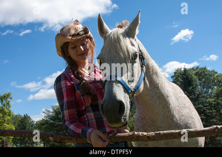 A cowgirl and her Arabian Horse Stock Photo