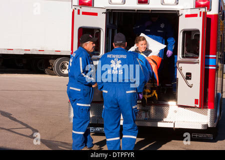 Newburg EMS EMTs loading a patient into an ambulance Stock Photo