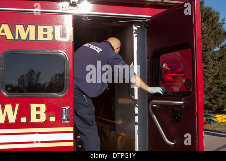 Fire Rescue EMT closing the door on an Ambulance Stock Photo