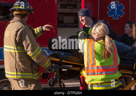 Emts loading a patient into an ambulance Stock Photo