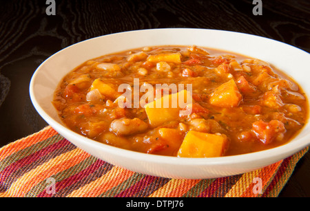 Hearty stew of pumpkin, tomatoes, beans and vegetables Stock Photo