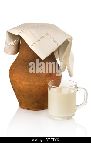 Old clay jug and mug of milk Stock Photo